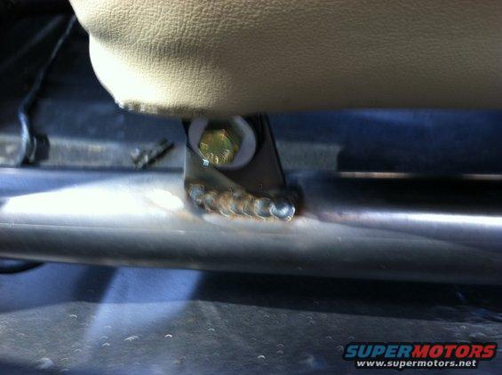 Interior seat bolt and bracket with visible welds