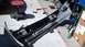 1993 Mercury Tracer - Car bumper and associated parts laid out on the ground for repair or replacement.