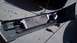 1993 Mercury Tracer - A car bumper is shown with an intercooler and associated piping, resting on the ground.