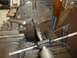 1964 Mercury Monterey - A metal rod is being threaded on a lathe using a tap wrench and cutting fluid.