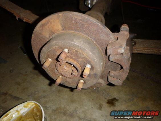 Rear drum brake assembly with rust and a tub of grease