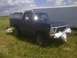 1979 Ford Bronco - This 1978 Ford Bronco is parked in a grassy field next to a trailer.