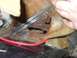 1979 Ford Bronco - This image shows significant rust and damage to a vehicle's metal components, with a red wire visible.