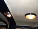 1979 Ford Bronco - Interior view of a vehicle's ceiling, showing two illuminated lights and dark trim.