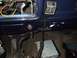 1979 Ford Bronco - Aftermarket stereo and CB radio installation visible in the interior of a dark blue vehicle.