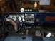 1979 Ford Bronco - The interior of a 1979 Ford Bronco shows a dashboard with gauges and an open radio slot.