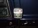 1979 Ford Bronco - Close-up of a CB radio and car stereo inside a vehicle.