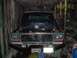 1979 Ford Bronco - This 1979 Ford Bronco is in a garage with its hood open, revealing the engine for maintenance.