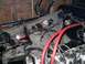 1979 Ford Bronco - The engine bay of a vehicle displays a tangled mess of wires and hoses, suggesting ongoing maintenance or repair.