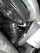 1979 Ford Bronco - A close-up view of engine components, including a belt and a hose assembly with clamps.