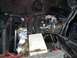 1979 Ford Bronco - The engine bay of a vehicle is shown with various components and hoses visible.
