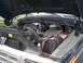 1979 Ford Bronco - The engine bay of a 1979 Ford Bronco, showing the battery and various engine components.