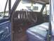 1979 Ford Bronco - The interior of a blue 1979 Ford Bronco features a blue bench seat and aftermarket gauges mounted on the dashboard.
