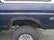 1979 Ford Bronco - This 1979 Ford Bronco shows significant rust around the rear wheel well, with a visible 4x4 decal on the quarter panel.