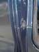 1979 Ford Bronco - Close-up of rust forming on the door jamb of a blue vehicle.