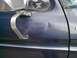 1979 Ford Bronco - This photo shows a dented door panel on a vehicle, with a warning sticker on the window.