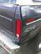 1979 Ford Bronco - Close-up of the rear passenger side of an SUV, showing the taillight, '4x4' decal, and chrome bumper.