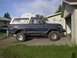 1979 Ford Bronco - This classic Ford Bronco is parked on a concrete driveway next to a residential garage.