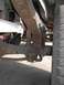 1979 Ford Bronco - Vehicle's rear leaf spring suspension system shows signs of rust and wear.