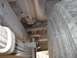 1979 Ford Bronco - A close-up view of the undercarriage of a vehicle reveals its suspension and tire, with a watermark indicating the source.