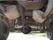 1979 Ford Bronco - This photo shows the rear axle, suspension, and dual exhaust system of a vehicle, including a visible fuel filter.