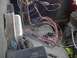 1979 Ford Bronco - A tangled mess of wires and connectors is visible in the engine bay of a vehicle.