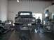 1979 Ford Bronco - Front view of a 1979 Ford Bronco on a lift in a workshop with a man standing next to it.