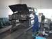 1979 Ford Bronco - A mechanic inspects the engine of a 1978 Ford Bronco, which is raised on a service lift in a garage.