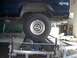1979 Ford Bronco - The rear wheel of a dark blue SUV is positioned on a dynamometer, with a '4x4' decal visible on the body.