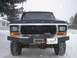 1979 Ford Bronco - A 1979 Ford Bronco is seen from the front, equipped with a winch and an aftermarket bumper, parked in a snowy environment.