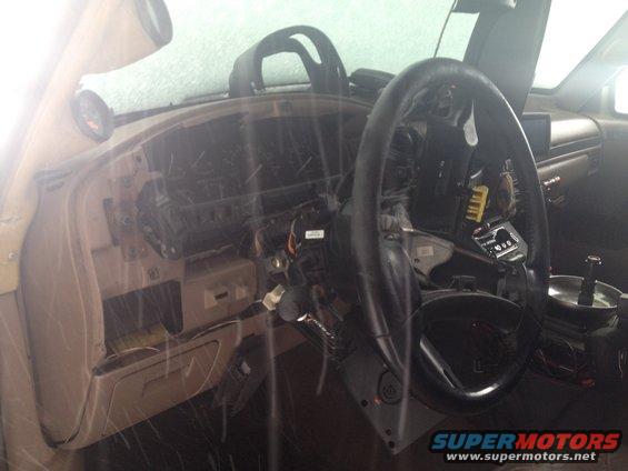 1993 Ford Bronco interior with dashboard disassembled, showing steering column and wiring