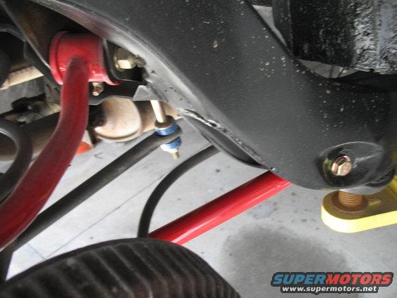 Red sway bar and black suspension parts on a vehicle