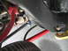 1972 Ford Ranchero - Close-up view of vehicle suspension components, including a red sway bar and black control arms.