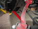 1972 Ford Ranchero - This image shows aftermarket red suspension components and a coil spring, likely from a vehicle's rear axle.