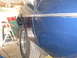 1972 Ford Ranchero - The side of a blue vehicle is shown, with a chrome trim line running along the body panel.