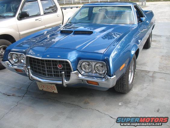 Blue 1972 Ford Ranchero parked next to a silver SUV