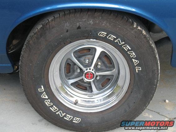 Close-up of a General tire on a chrome wheel with a red center cap