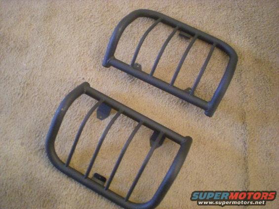 pair of black metal headlight guards