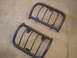 1993 Ford Bronco - Two aftermarket headlight guards are shown lying on a carpeted surface.