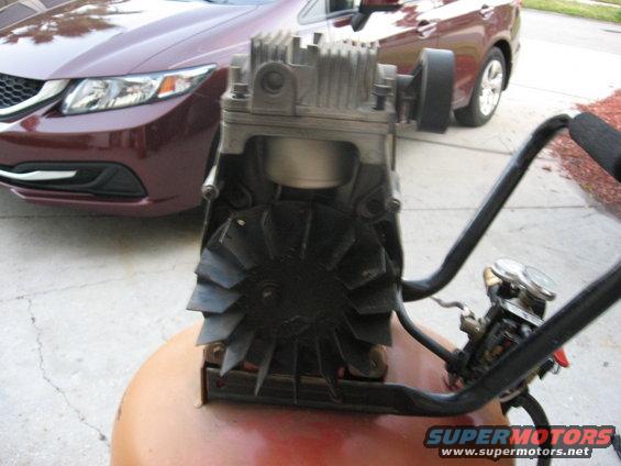 air compressor in front of a maroon car