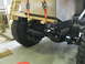 1992 Ford Bronco - A vehicle's frame and suspension are visible as a large crate is lowered onto it.