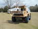 1992 Ford Bronco - A custom-built vehicle with a unique design and large off-road tires is shown outdoors.