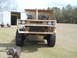 1992 Ford Bronco - A partially constructed vehicle made of wood sits outdoors with a dog in the foreground.