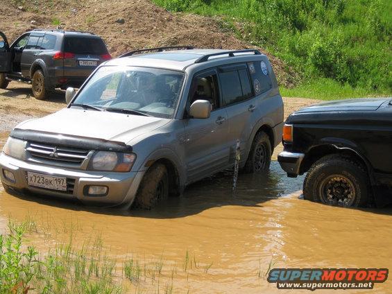 Silver Mitsubishi Pajero/Montero stuck in mud, front view