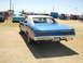 1967 Pontiac GTO - Rear view of a blue 1967 Pontiac GTO with a white vinyl top, parked outdoors with other vehicles and people around.