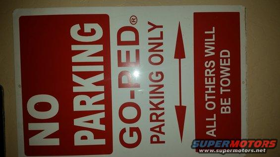 No parking sign with red and white text: 'NO PARKING GO-PED PARKING ONLY' and 'ALL OTHERS WILL BE TOWED'