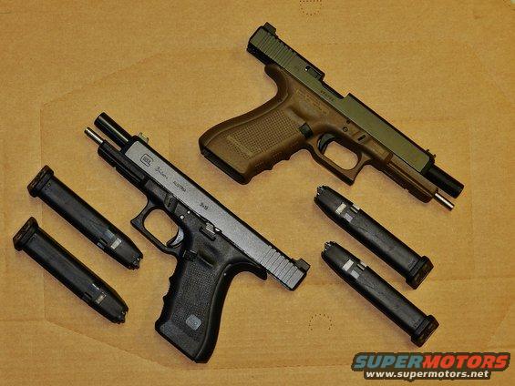 Two Glock handguns, one black and one tan with green slide, with four magazines on a brown surface