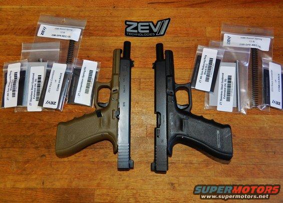 Two handguns with ZEV Technologies parts laid out on a wooden surface