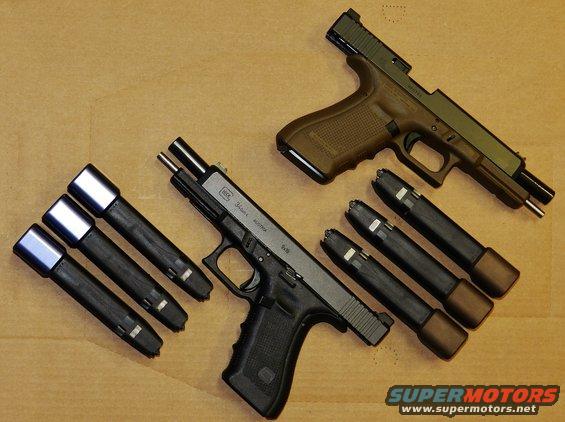 Two Glock pistols with magazines laid out on a wooden surface