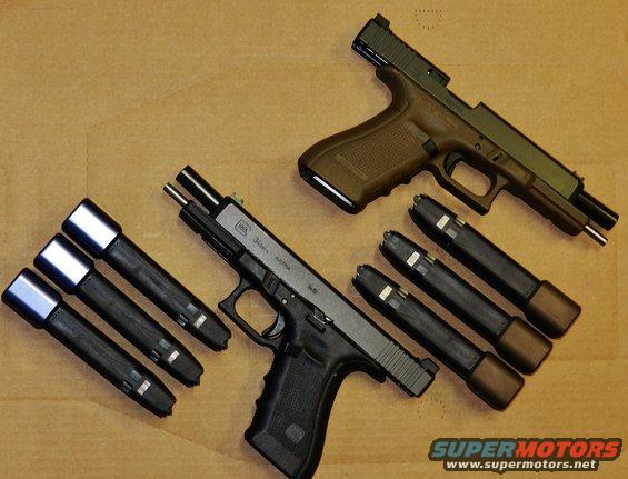 Two Glock pistols, one black and one tan, with several magazines laid out on a brown surface